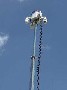 Multi-camera security array mounted on top of a tall telescopic mast