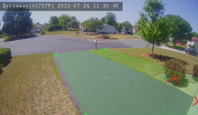 Security camera monitoring a residential driveway.