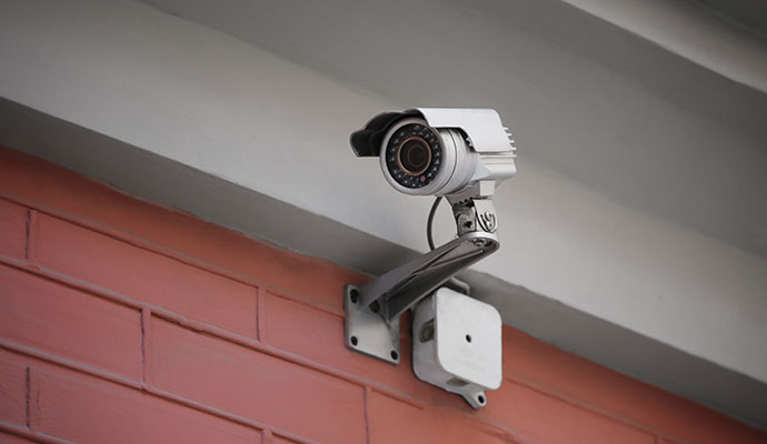Bullet camera mounted on red brick wall