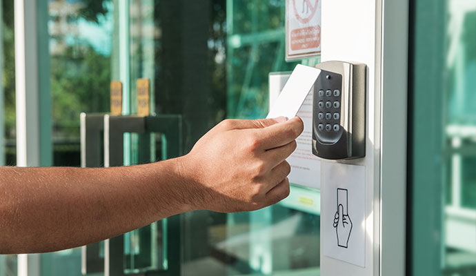 A person using key card reader access control system
