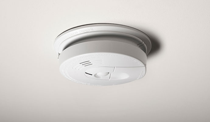 White smoke detector on ceiling