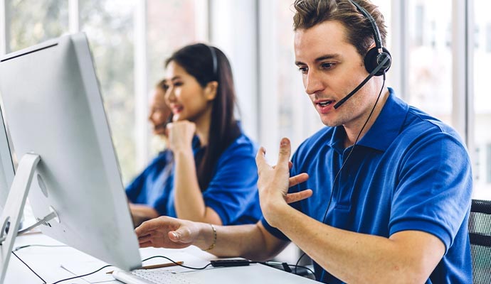 Customer support representatives assisting clients through headset communication