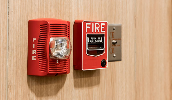 Fire alarm horn and pull station on wood wall