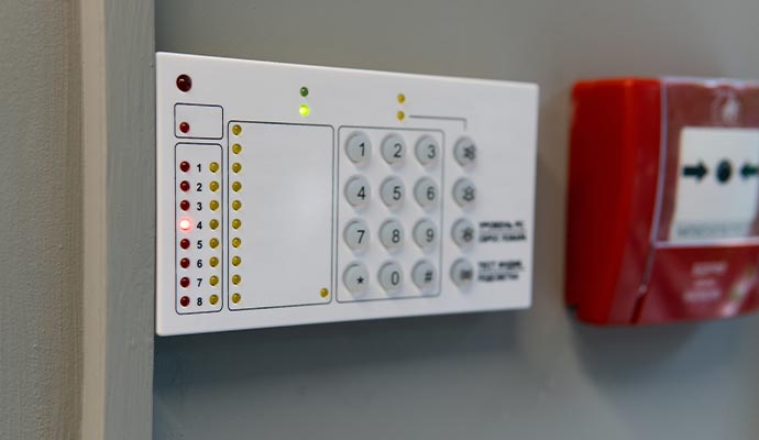 Wall-mounted fire alarm keypad panel with status indicators and emergency control interface
