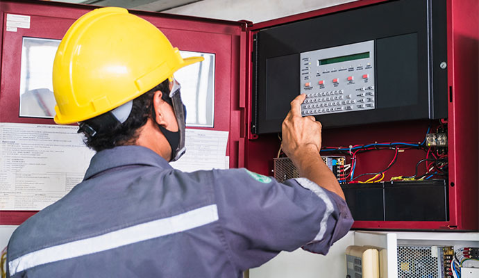 A professional inspecting fire alarm system