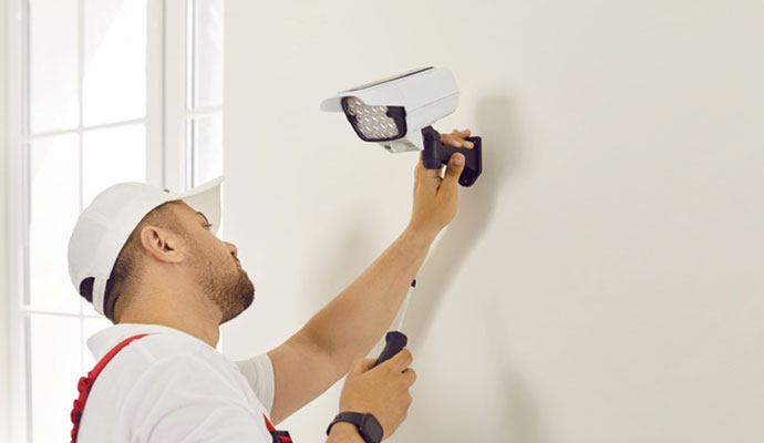 Technician installing box security camera