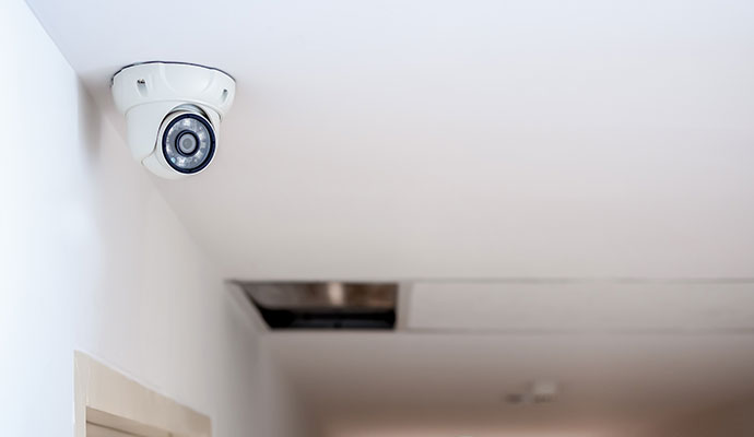 White dome security camera on ceiling
