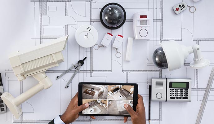 Integrated security system setup with cameras, sensors, alarm devices, and remote monitoring controls