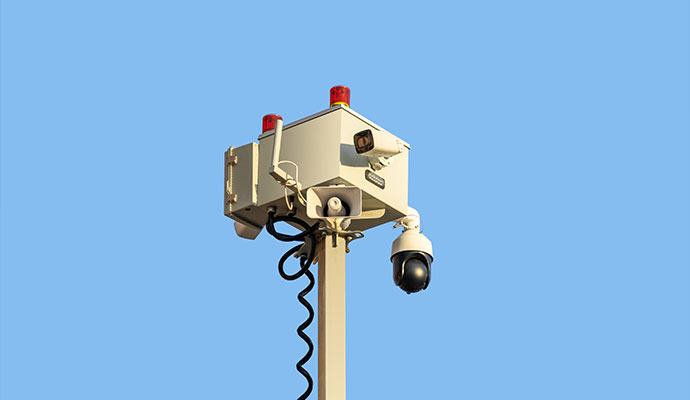 Security camera box with red strobe lights and spiral cable