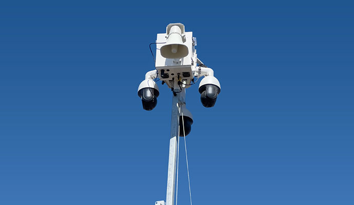 Surveillance mast head featuring loudspeaker and dome cameras