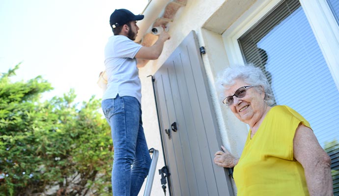 Technician installing home security camera