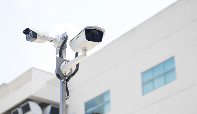 Two bullet cameras on pole outside commercial building