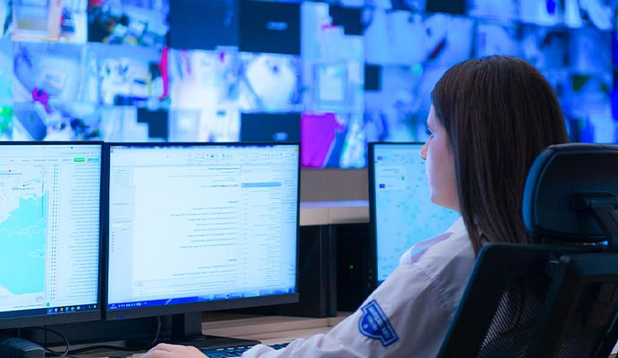 Woman monitoring security control room